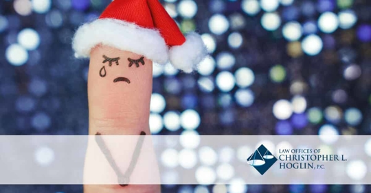 finger with santa hat and sad face drawn on
