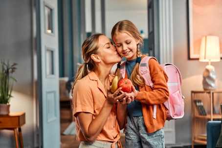 mother sending her daughter off to school