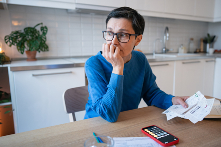 stressed woman calculating budget