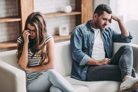 couple looking away from each other on couch