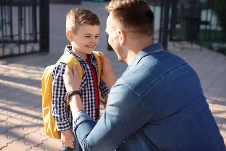 father getting son ready for school